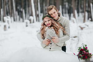 Newlyweds are hugging in the winter forest couple in love winter wedding