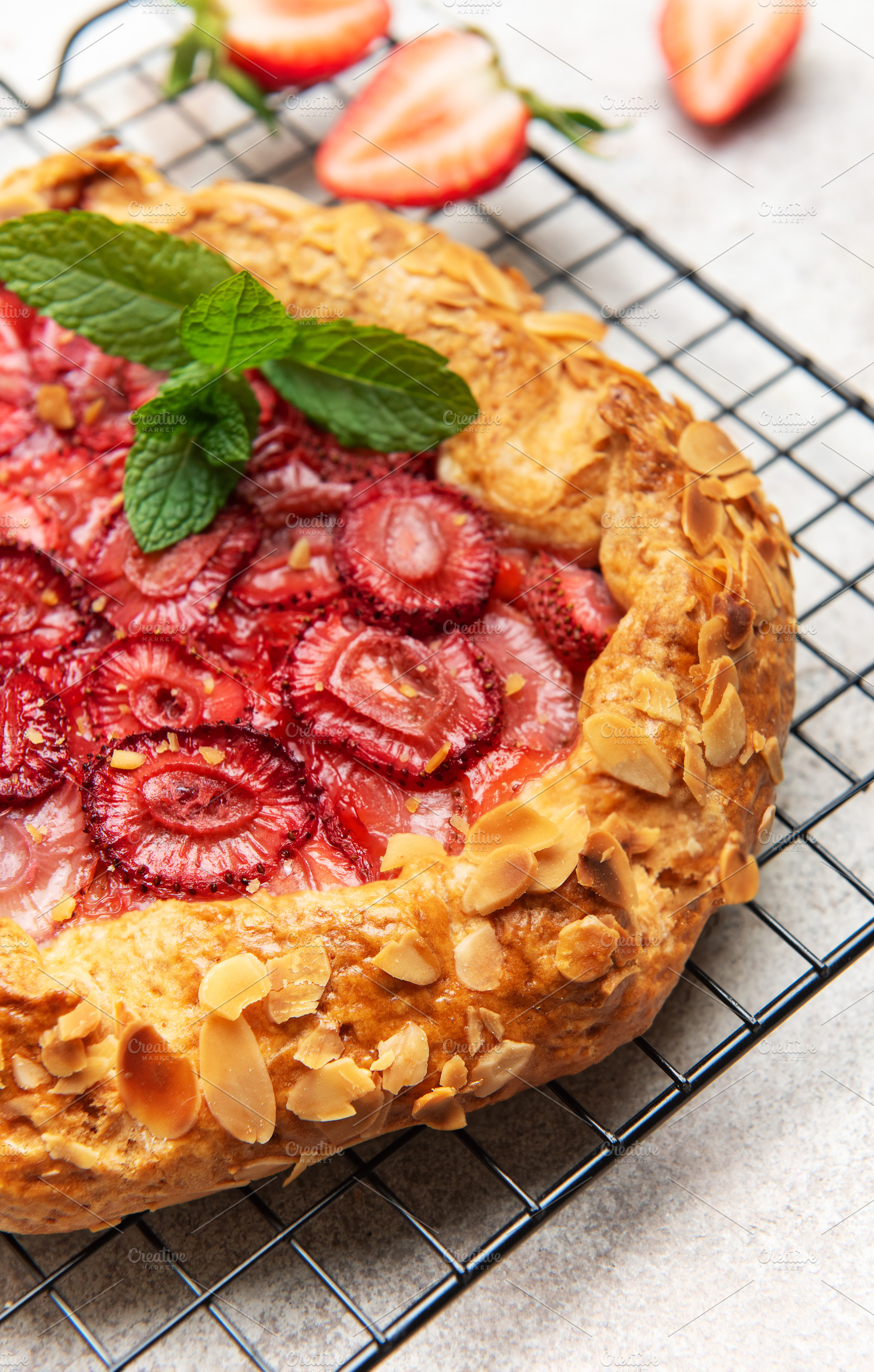 Delicious homemade strawberry galette cooling on a wire rack, a Food & Drink Photo by Olena Rudo