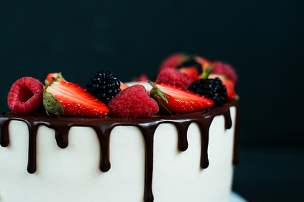Close-up cake on black background, with strawberry raspberries. Dietary white cream, with chocolate flavors., a Food & Drink Photo by byswat