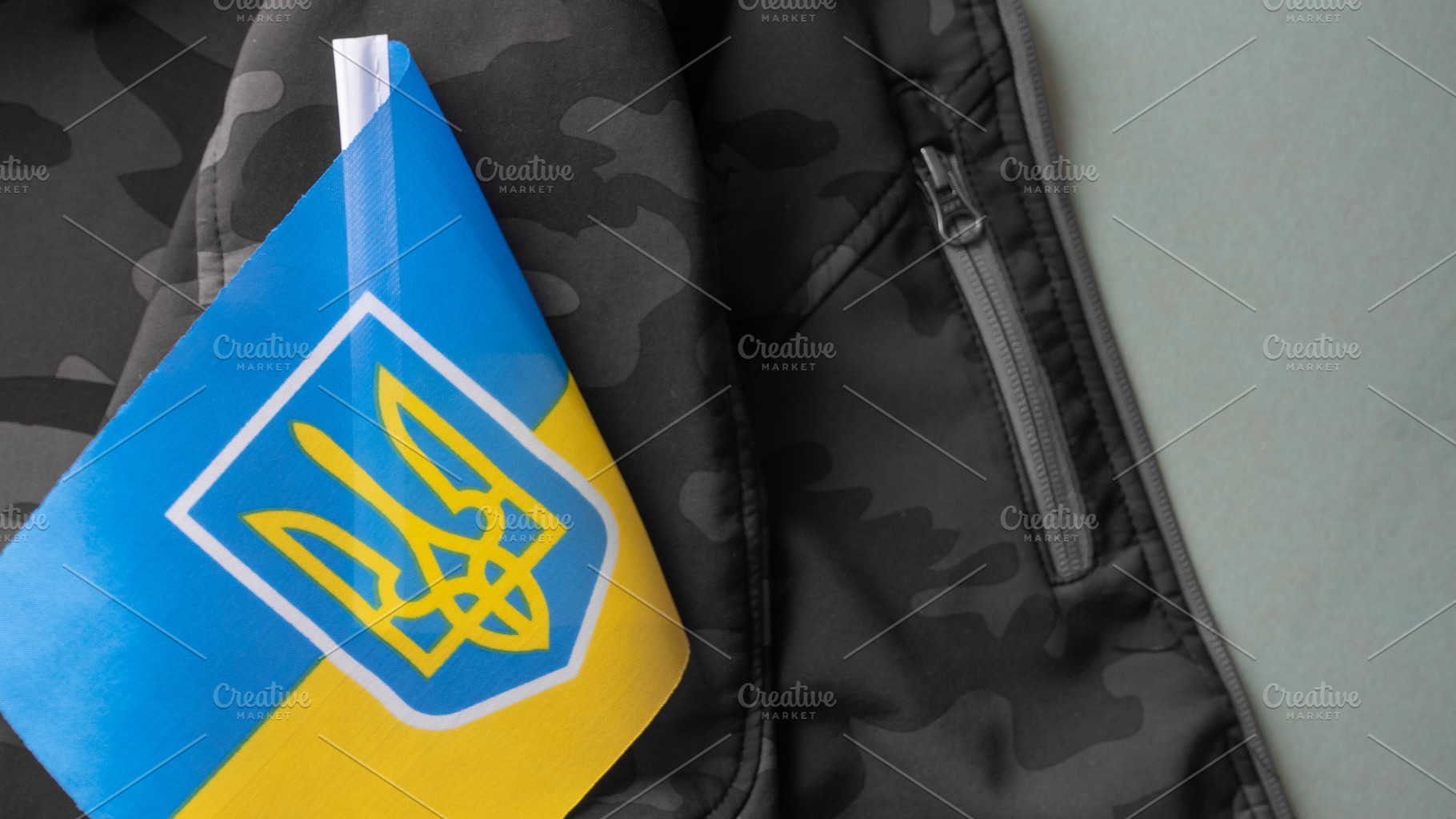 Ukrainian flag on military uniform, a Background Photo by OleksandrRybitskyi