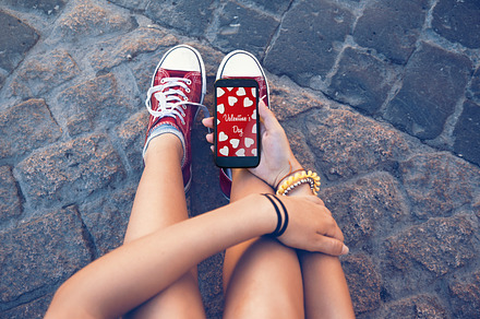 Teenager with mobile valentine mess containing phone, smart, and tenn, a Holiday Photo by SZ IMAGE