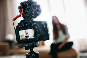 Young woman recording video featuring blog, blogger, and blurred background, a Technology Photo by Jacob Lund