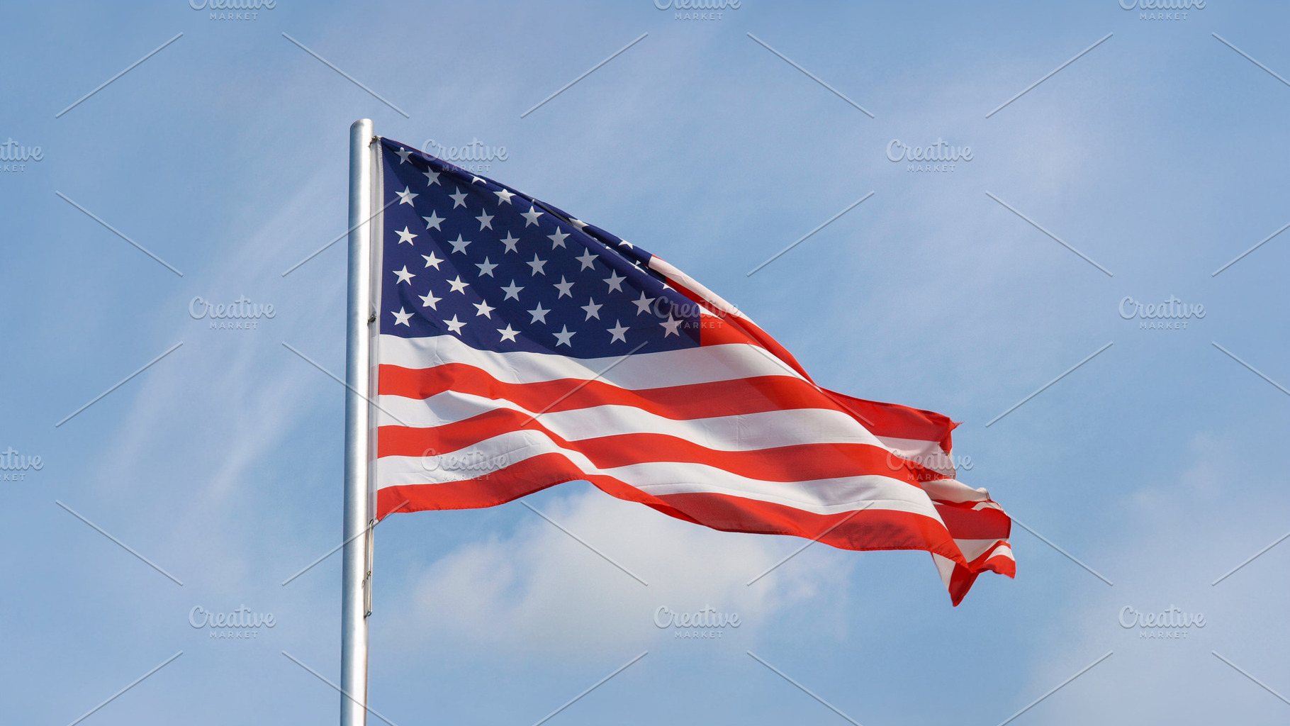 American flag of United States of America over blue sky, a Photo by WorldOfPhotos