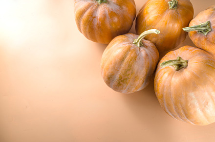 Autumn pumpkins on beige autumn background, a Food & Drink Photo by Rimma