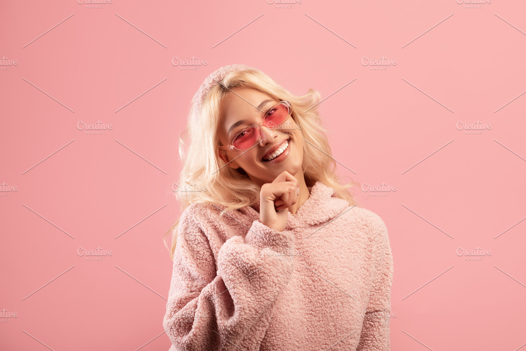 Happy young lady touching chin and smiling at camera, wearing stylish colorful, a Photo by Prostock-Studio