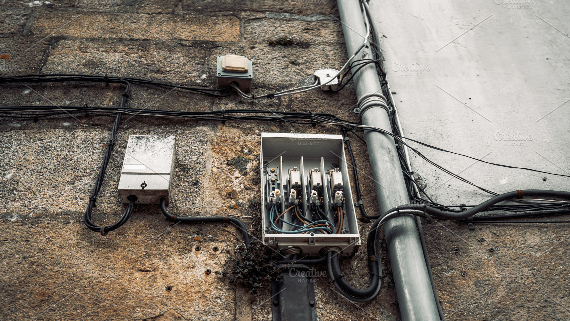 Old electrical box on stone wall, a Technology Photo by SkyNext