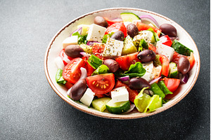 Greek salad in craft plate on black, a Food & Drink Photo by Nadia-nb