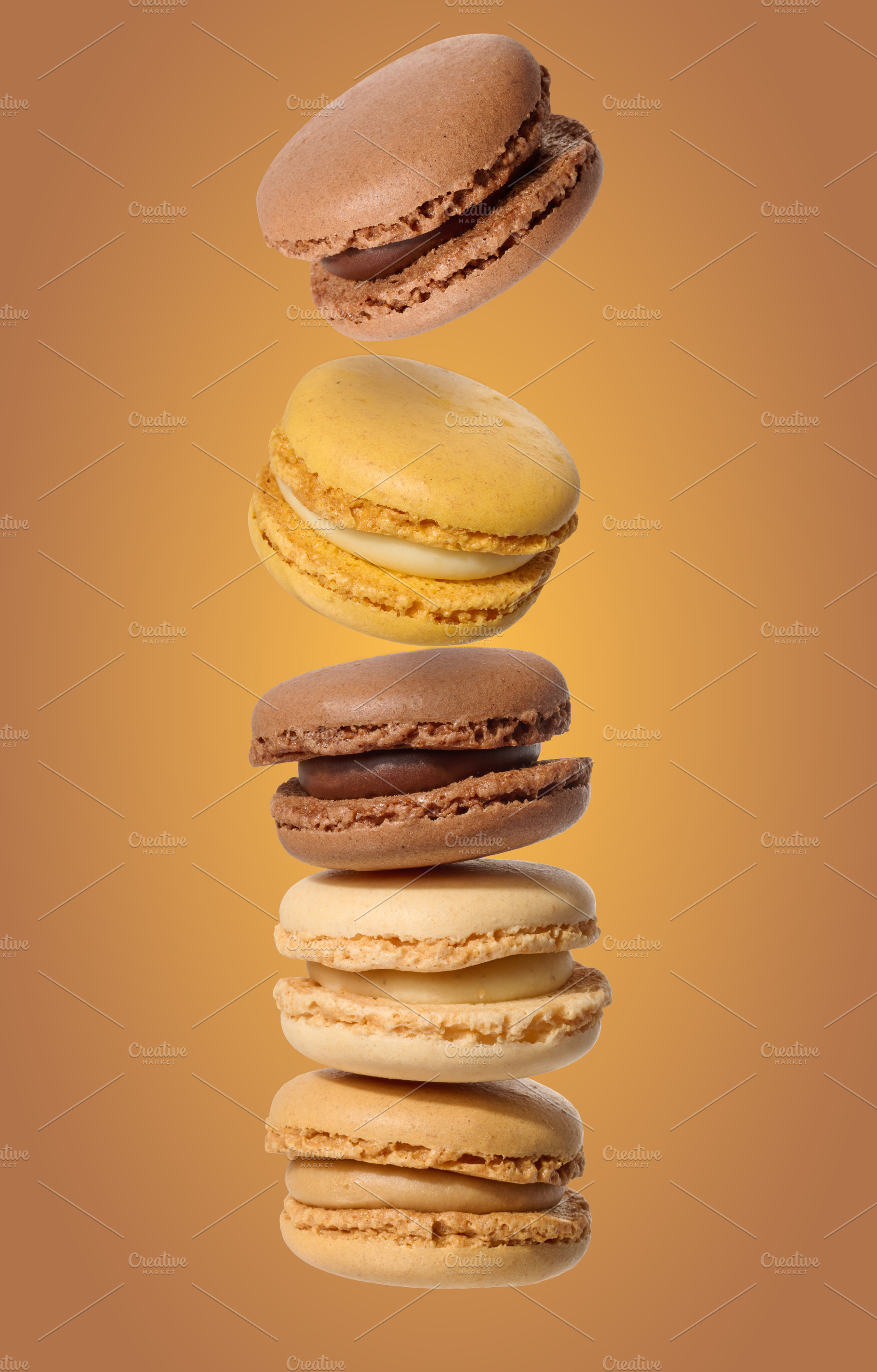 A vertical stack of five multi-colored macarons in chocolate, va, a Food & Drink Photo by ndanko