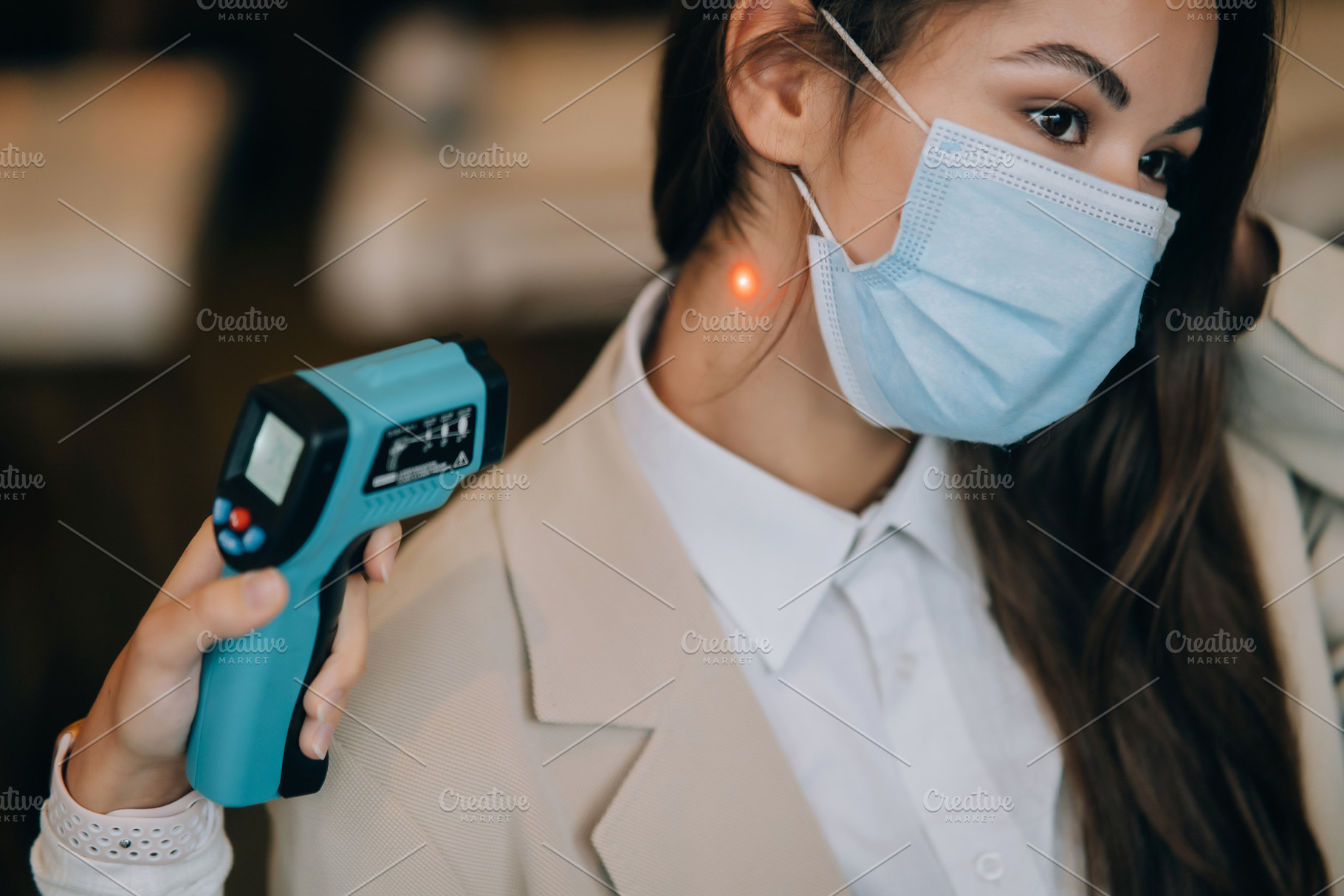 Measuring body temperature with contactless body thermometer, a Person Photo by Tekso