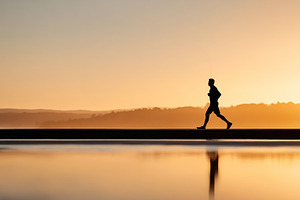 Silhouette of a man jogging along, a Person Photo by MistyDay