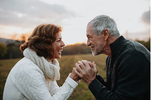 Senior couple holding hands in, a Nature Photo by HalfPoint