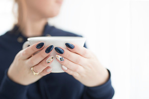 Woman's hands with a cup featuring nails, hands, and cup