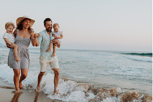 Young family walking on sandy shore, a Person Photo by HalfPoint