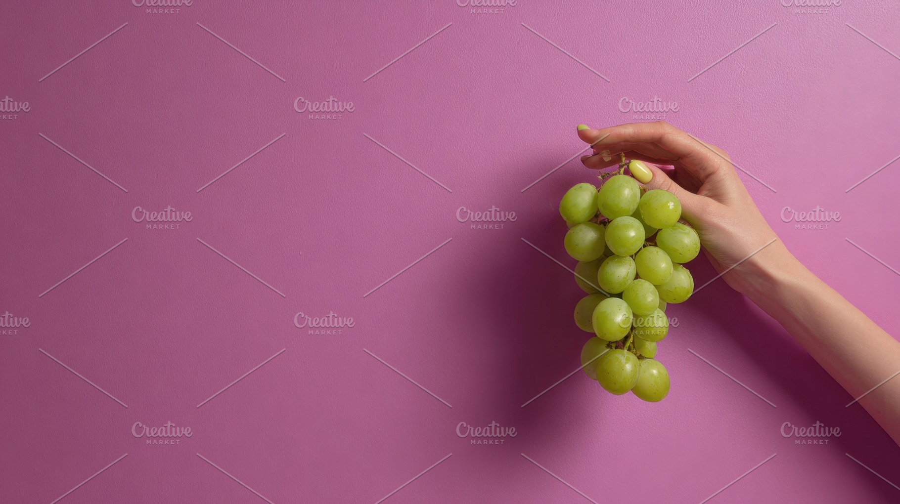 Hand holds bunch of green grapes, a Photo by Beautiful things