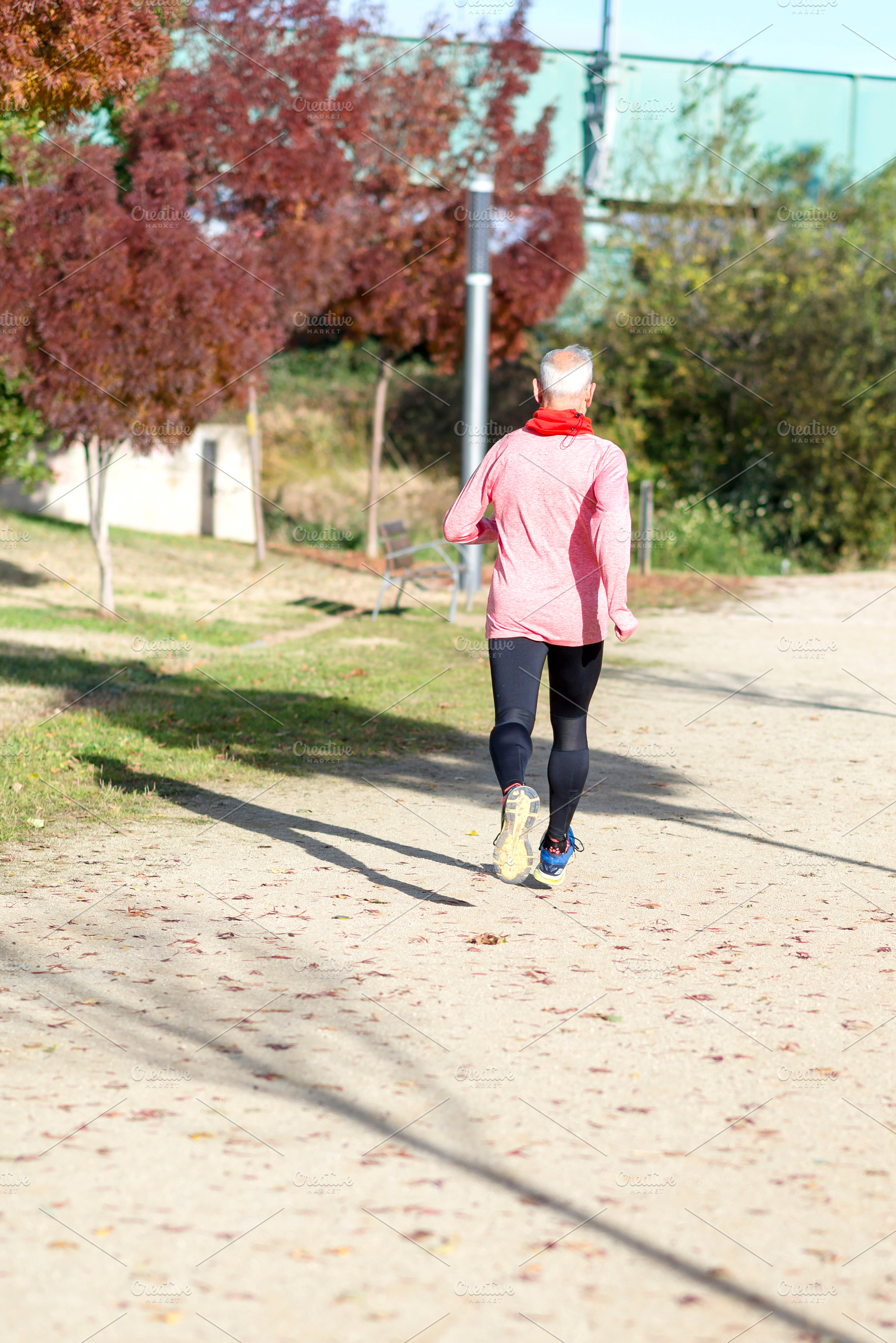 Senior man jogging in the park on a sunny day, a Sports & Recreation Photo by RF Images