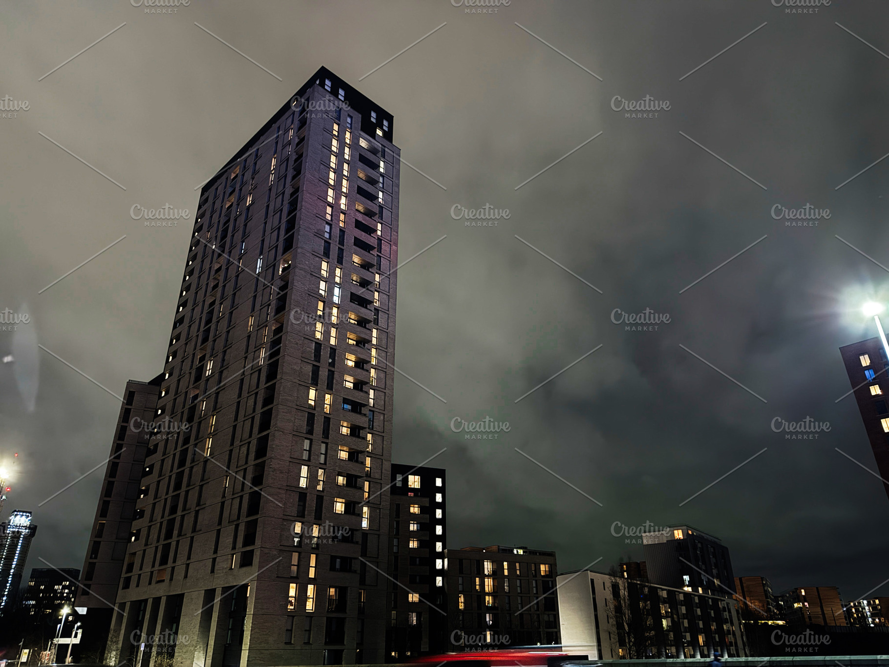 Night view of tall residential tower in Manchester city at night with illuminat, a Photo by AS photostudio