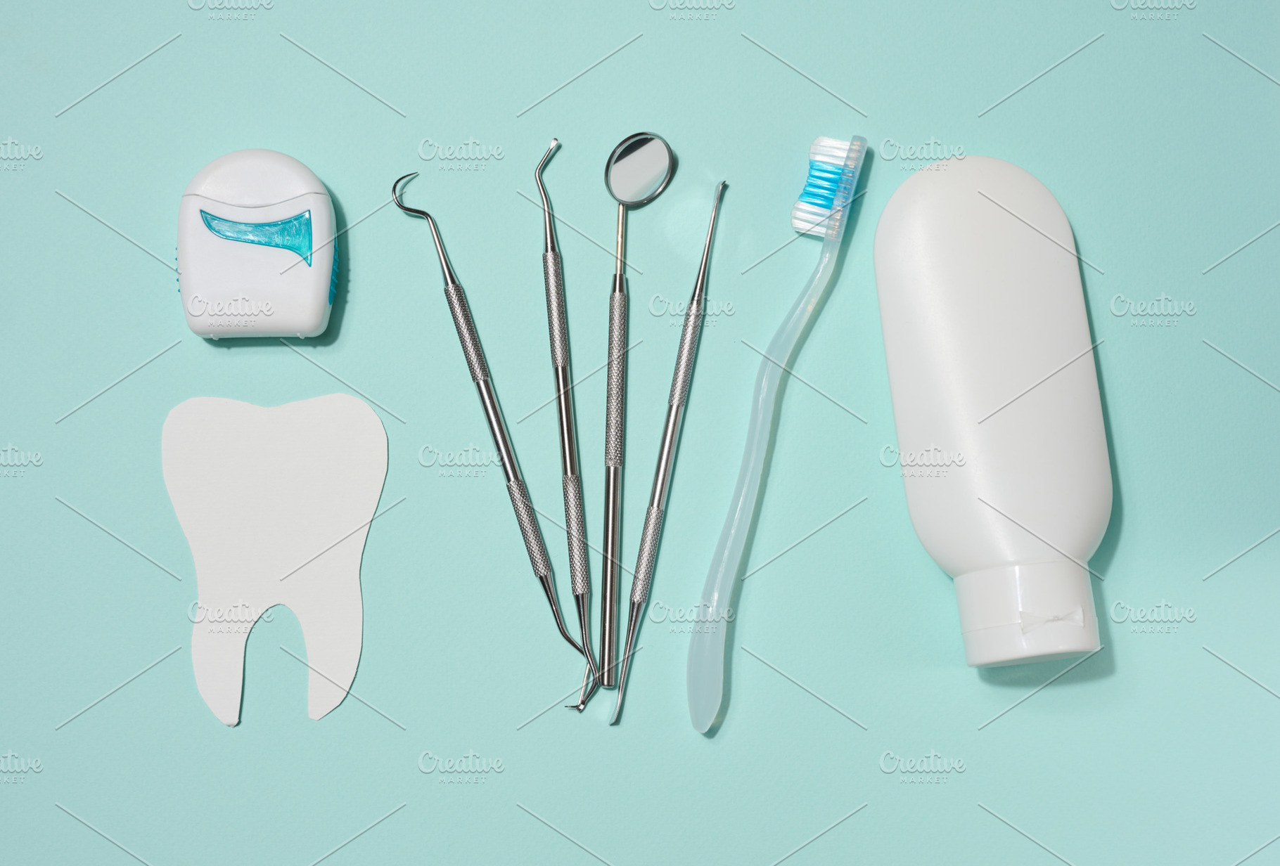 White tube of toothpaste, dental floss in white case, dental ins, a Health & Medical Photo by ndanko