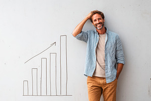 Man beside drawn bar graph representing growth, a Business Photo by AlyaAnd