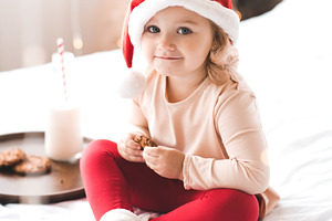 Baby girl with breakfast in bed