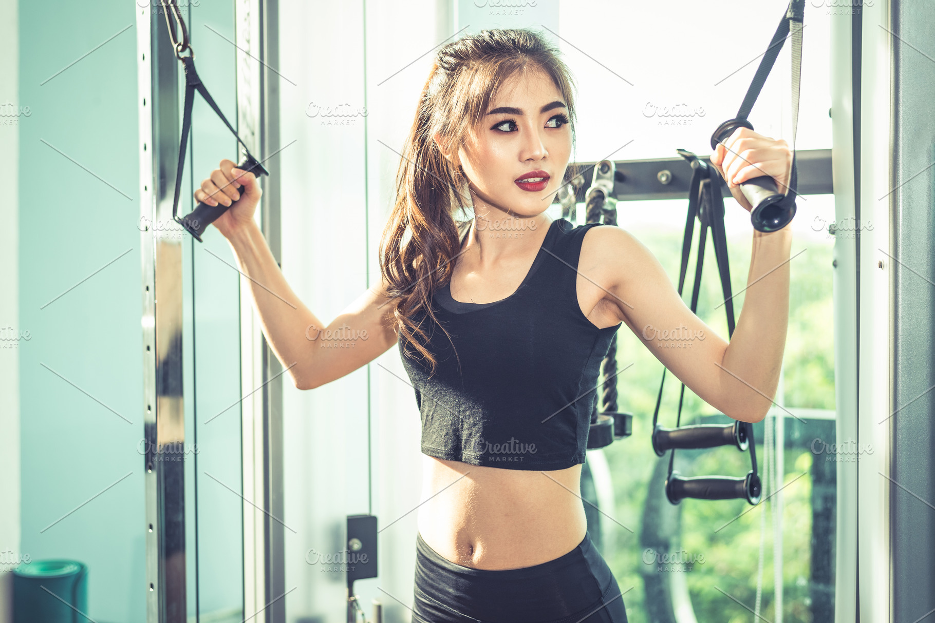 Asian young woman doing elastic rope exercises at cross fitness, a Sports & Recreation Photo by Ministocker