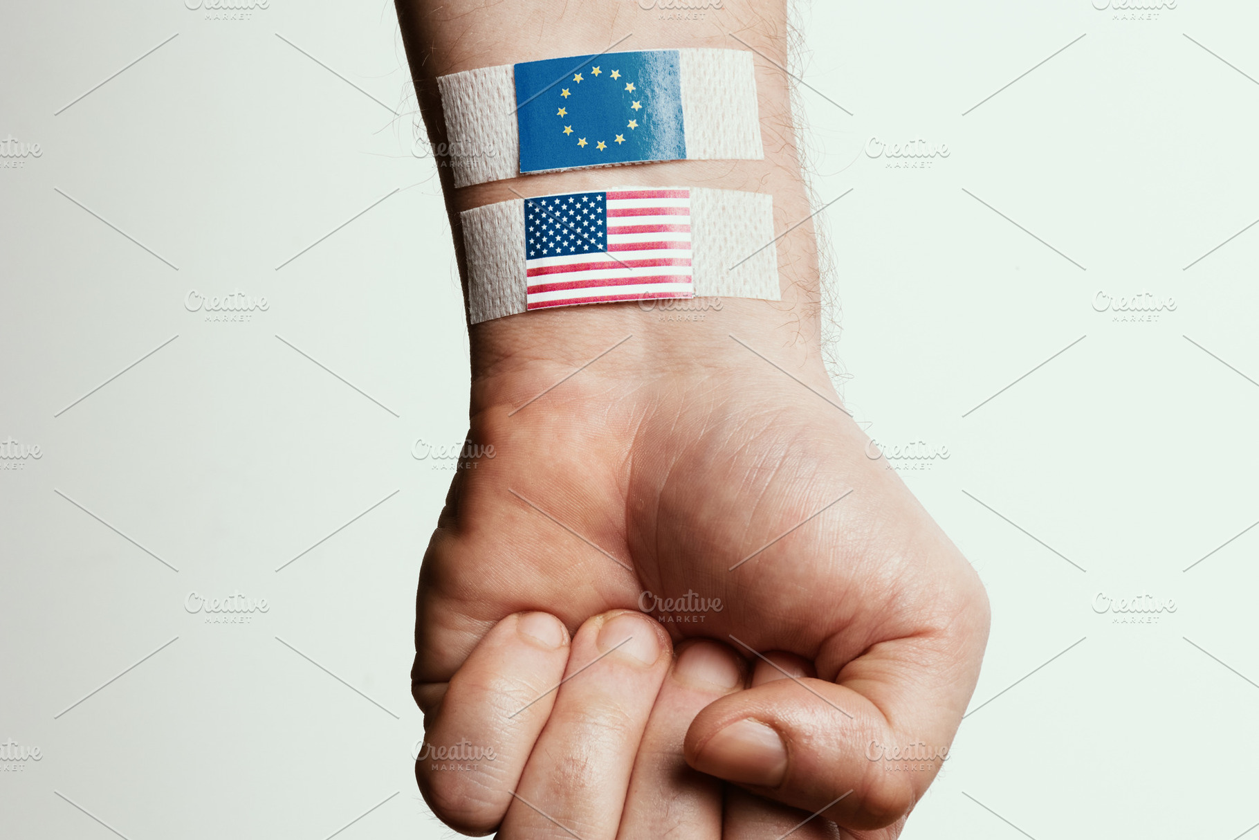 Hand with Bandaged Flags of USA and EU, a Business Photo by Alliance Images