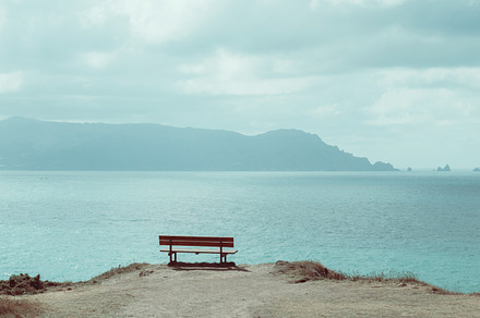 Old bench containing bench, cliff, and coast