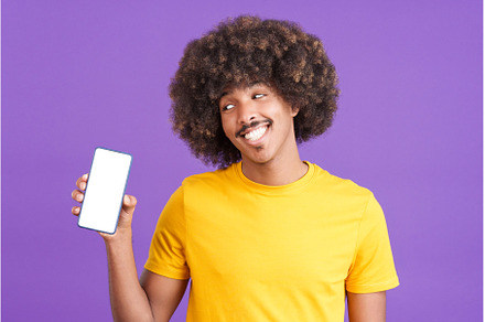 Smiley african man holding a mobile, a Person Photo by Iván Moreno STOCK PHOTO