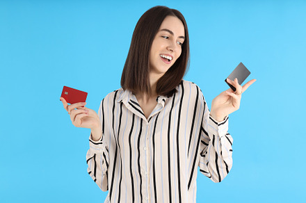 Attractive woman with cards on blue background, a Person Photo by AtlasStudio PRO