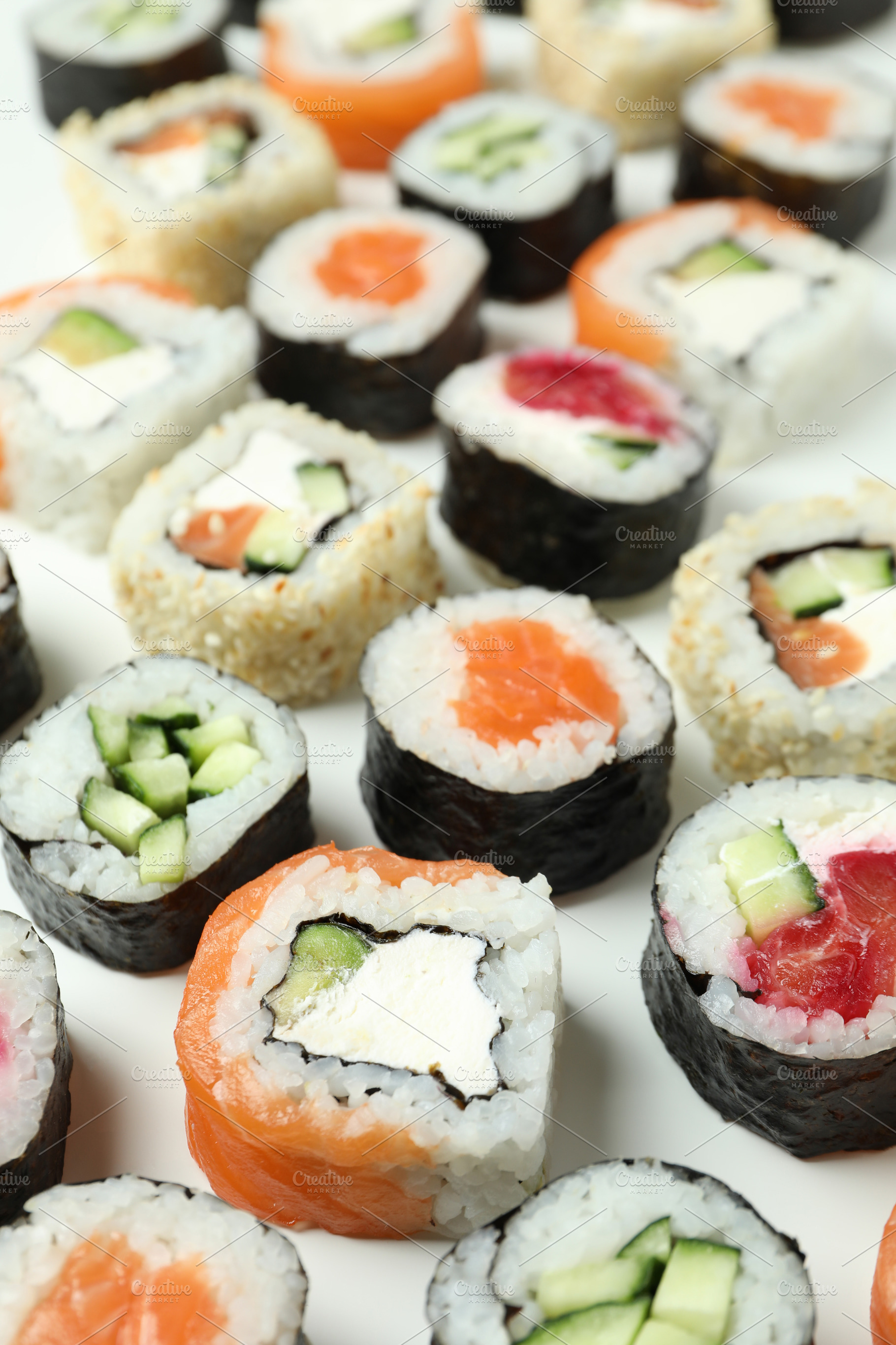 Concept of tasty food with sushi rolls on white background, a Food & Drink Photo by AtlasStudio PRO