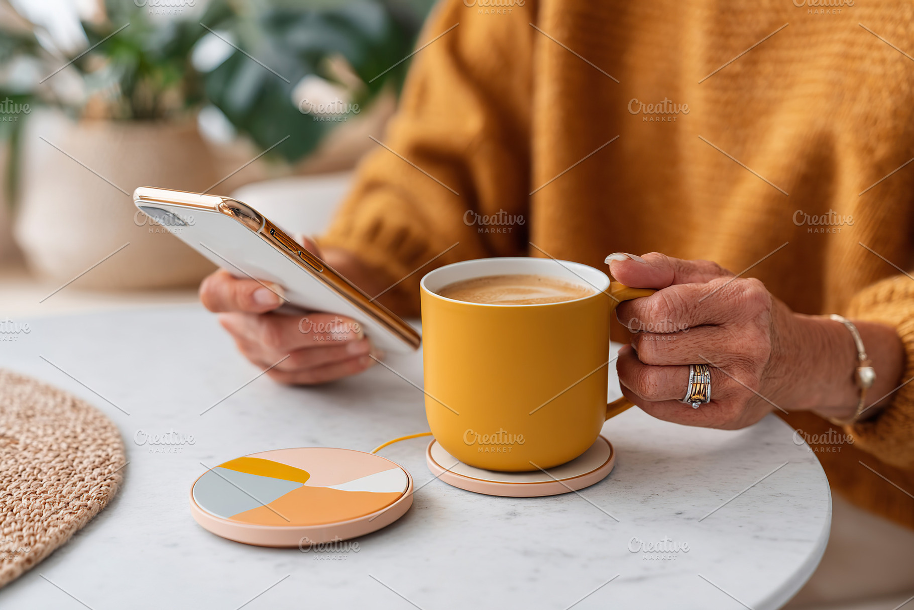 Enjoying coffee while browsing on a smartphone in a cozy cafe setting, a Photo by AlyaAnd