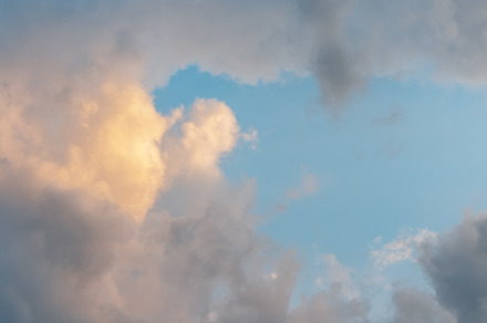 Blue sky with white and yellow fluff
