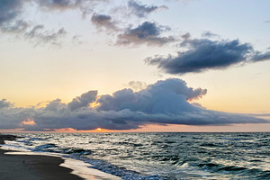 Sunset over a calm Florida Pensacola beach with waves, clouds, and warm light o, a Nature Photo by AS photostudio