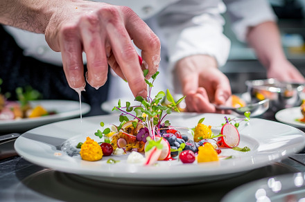 A chef carefully arranges colorful i, a Photo by Iftikhar Alam