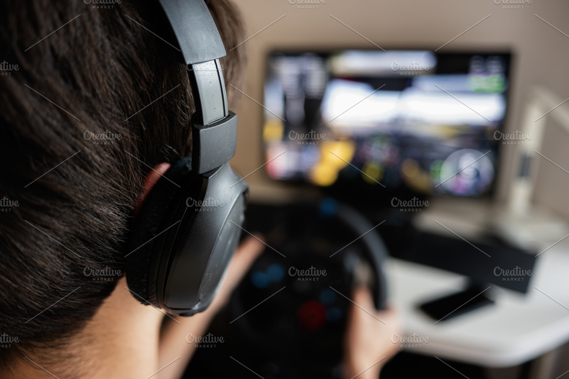 Person gaming with steering wheel controller in home setup for virtual simulati, a Photo by AS photostudio
