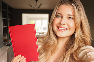 Happy blonde woman smiling at camera, holding blank red book for, a Person Photo by Studio ANNA
