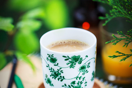 Cup of coffee on spring background