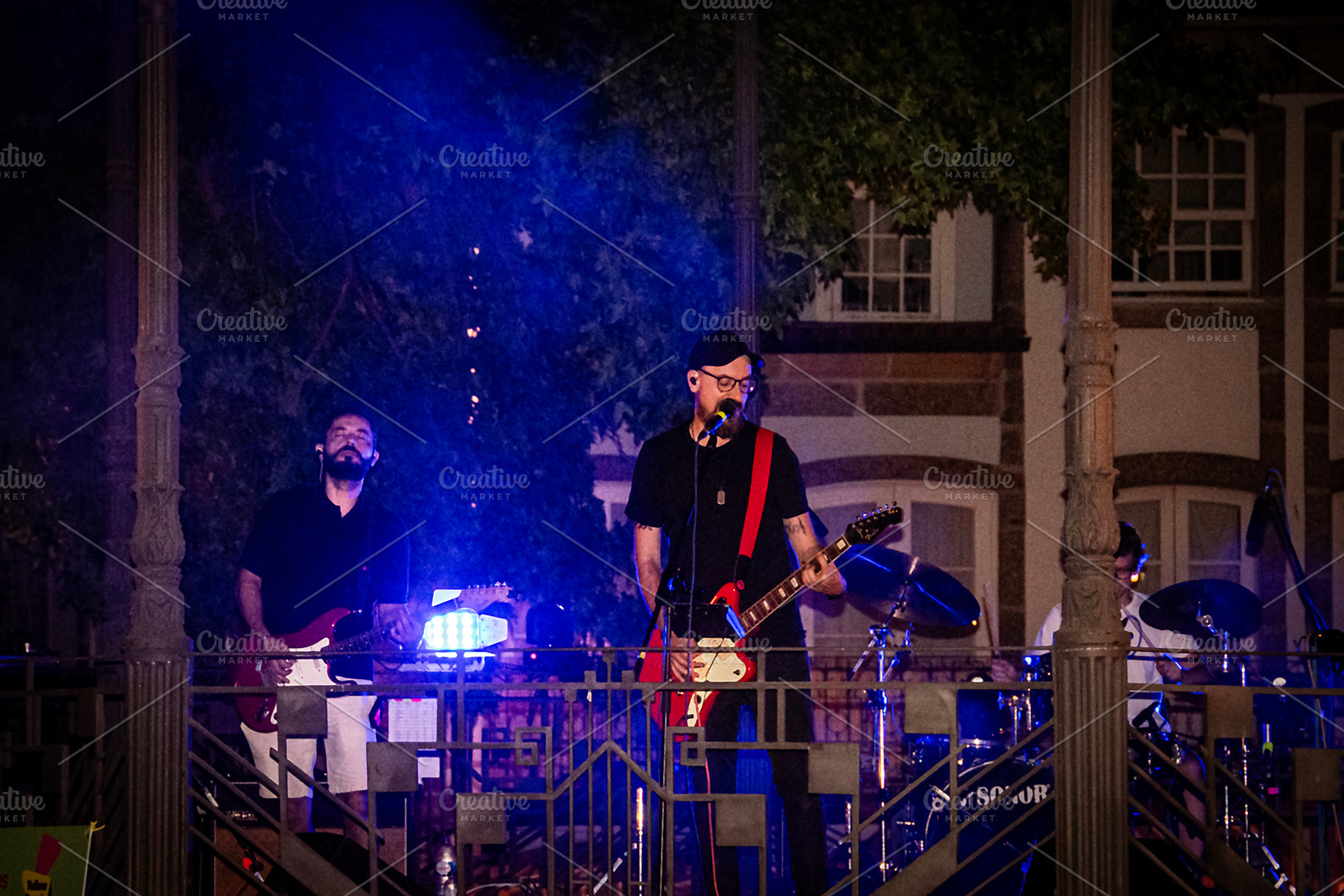 Live music performance at night with dramatic blue lighting, a Person Photo by DanFLCreativo