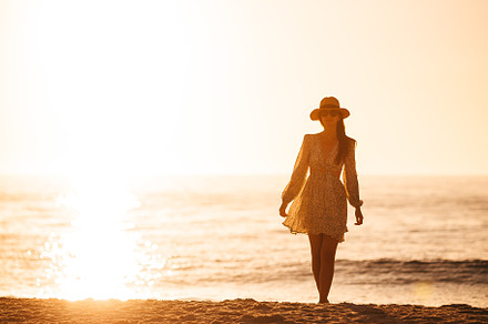 Young happy woman on the beach enjoy her summer vacation. Beautiful woman in ha, a Person Photo by travnikovstudio
