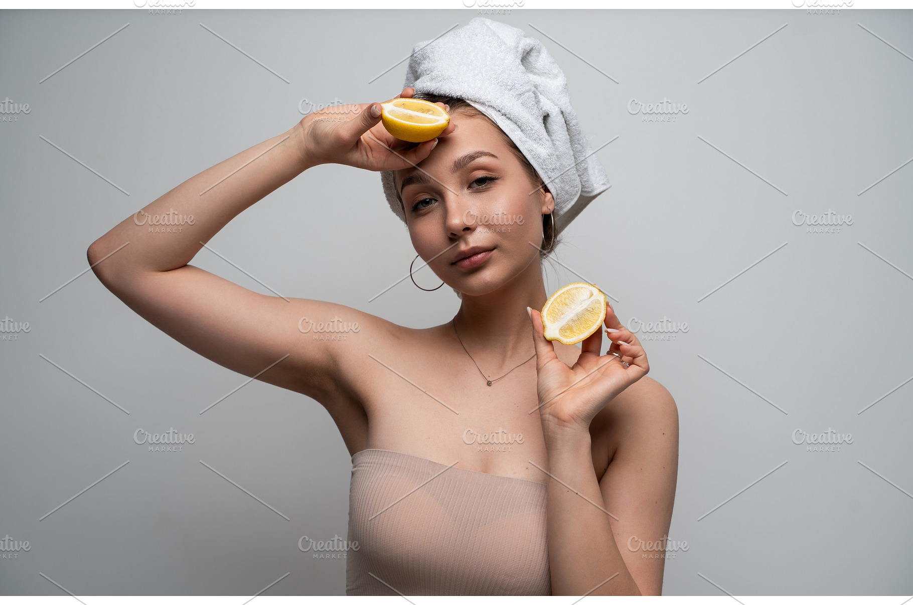 Young woman with a towel wrapped, a Health & Medical Photo by volodymyrshtun13795