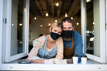 Coffee shop owners with face masks containing concept, coronavirus, and corona, a Person Photo by HalfPoint