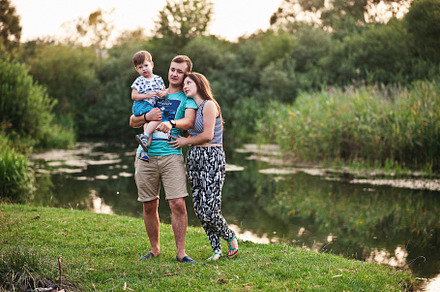 Happy young family: mother, father,  children son on nature havi, a Person Photo by AS photostudio
