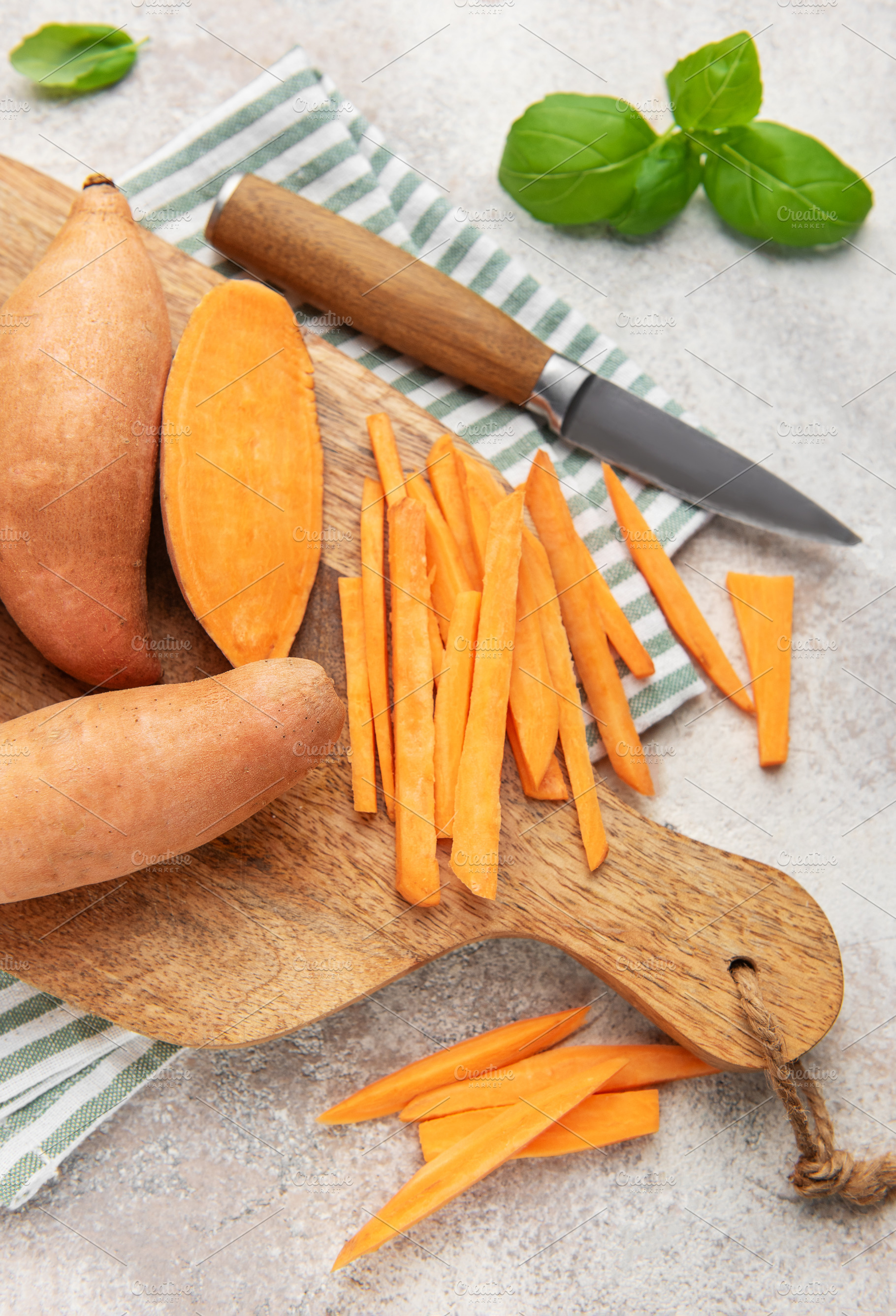 Preparing sweet potato fries on a wooden cutting board, a Food & Drink Photo by Olena Rudo