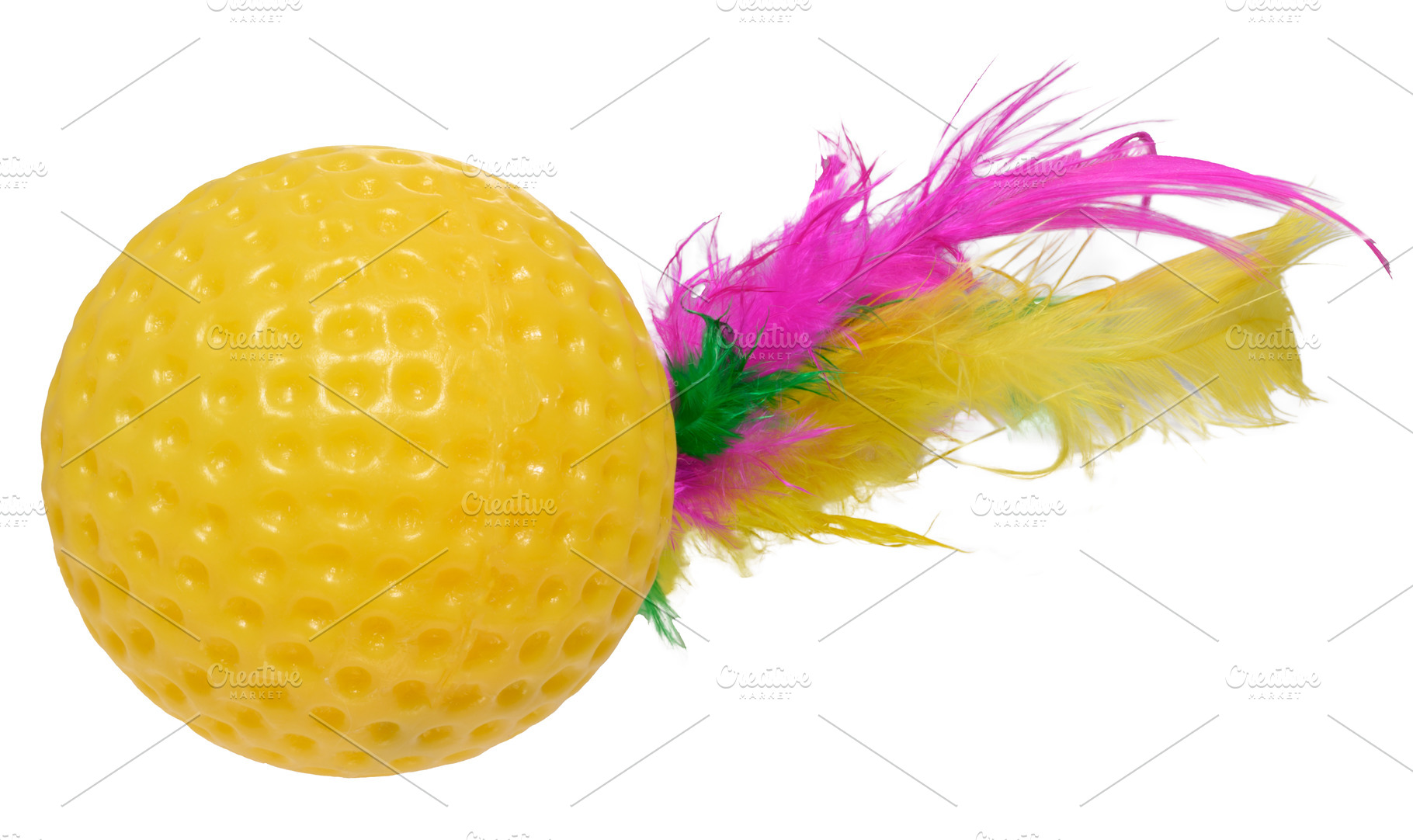 A bright yellow rubber ball toy with a golf ball texture and col, an Abstract Photo by ndanko