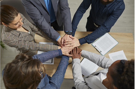 Business people group putting their, a Business Photo by StudioRomantic