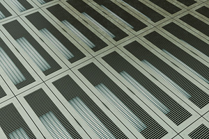 Industrial metal grid floor with illuminated rectangular patterns, an Industrial Photo by RF Images