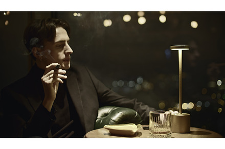 Young man elegantly smokes cigar, a Person Photo by Media Whale Stock