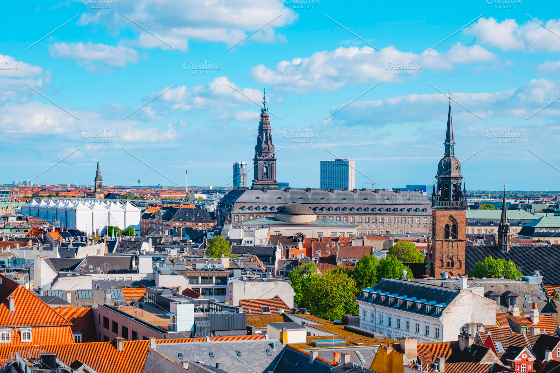 Christiansborg spire above Copenhagen rooftops, a Photo by Nito