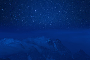 Night mountains and stars in sky containing landscape, mountain, and nature