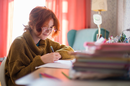 schoolgirl with glasses doing homework., a Photo by Pictures for you!!!!!!!!!