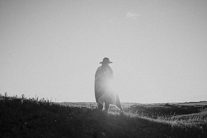 Woman in a field at sunset
